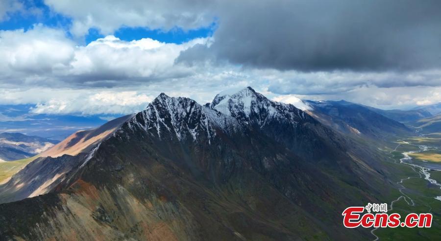 Snowy peaks of Tianshan Mountains in clouds-1