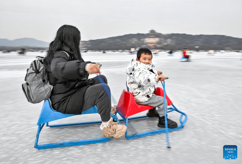 Tourists have fun on frozen lake at Summer Palace in Beijing-2