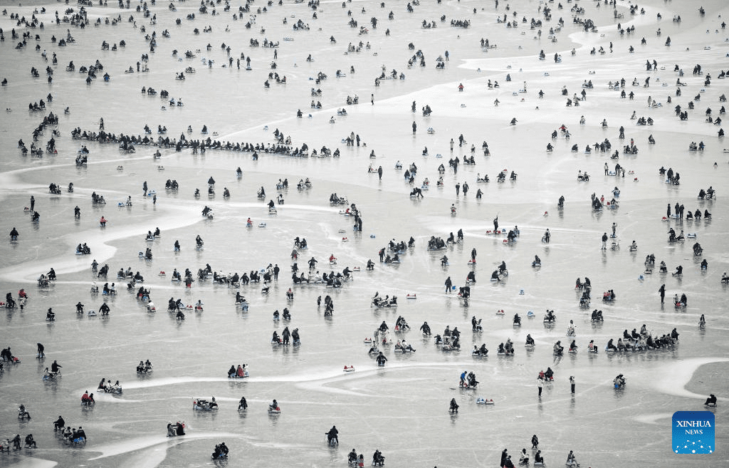 Tourists have fun on frozen lake at Summer Palace in Beijing-5