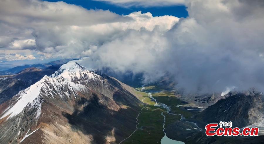 Snowy peaks of Tianshan Mountains in clouds-3