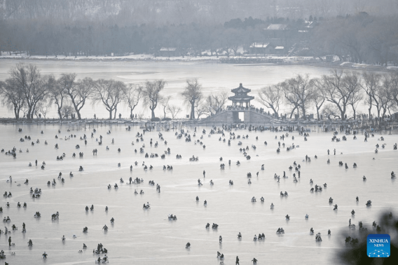 Tourists have fun on frozen lake at Summer Palace in Beijing