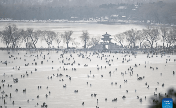 Tourists have fun on frozen lake at Summer Palace in Beijing